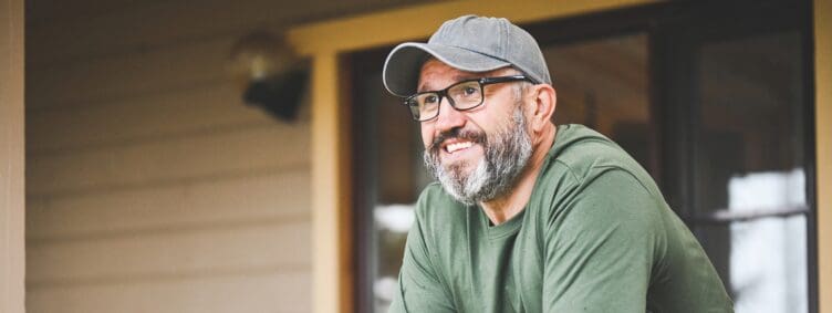 happy mature adult man on his porch at home