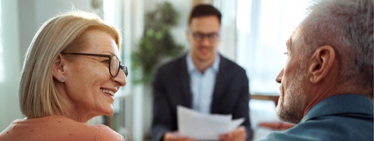 senior couple with financial professional for retirement planning