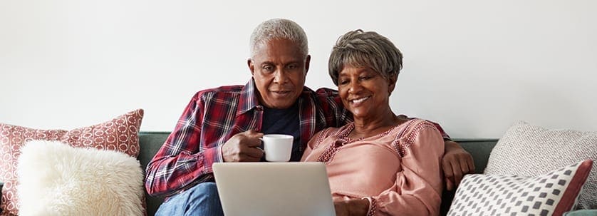 Couple searches on their tablet for great reverse mortgage rates (Longbridge Financial)