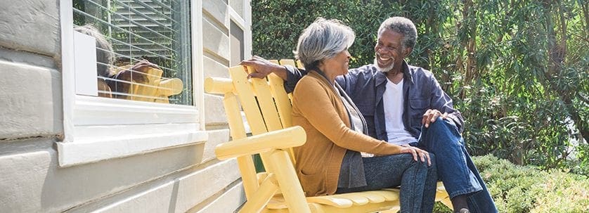 senior-couple-sitting-on-porch-at-home