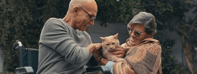 senior-couple-outside-wheelchair-pet-cat