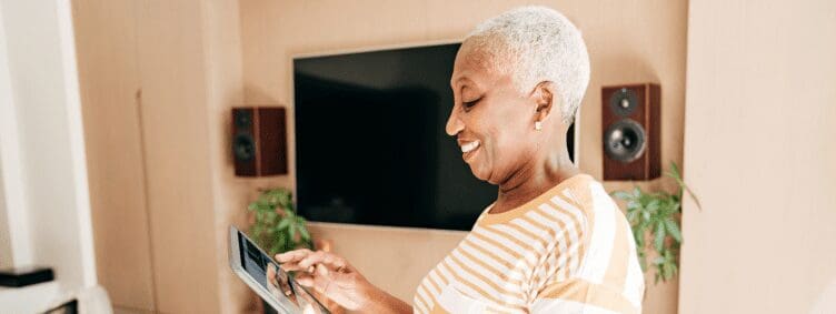 happy-smiling-black-african-american-senior-woman-female-home-living-room-tablet