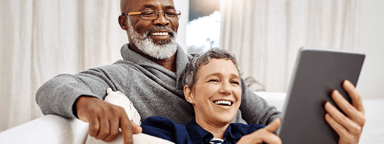 shot-of-an-affectionate-senior-couple-using-a-tablet-while-relaxing-on-the-sofa-at-home