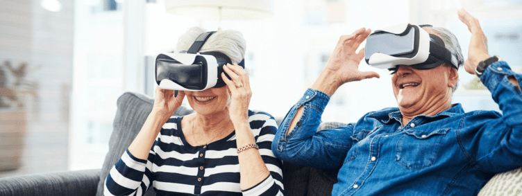Senior couple on couch with virtual reality devices