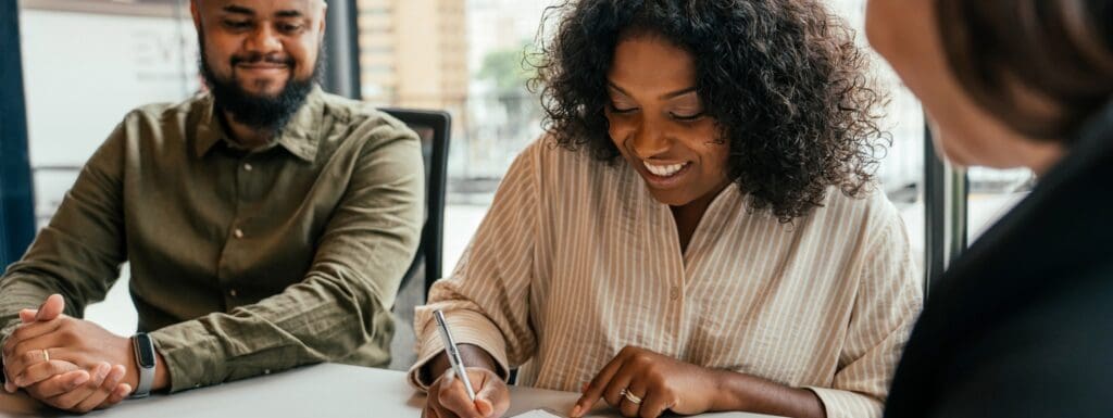 Homeowners sign their reverse mortgage closing documents during their final loan appointment