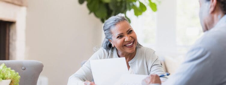 Older homeowner reviewing paperwork after closing on a reverse mortgage